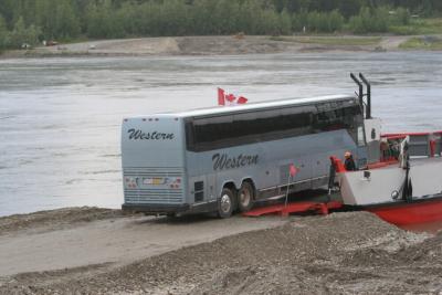 A tour bus loads on another run